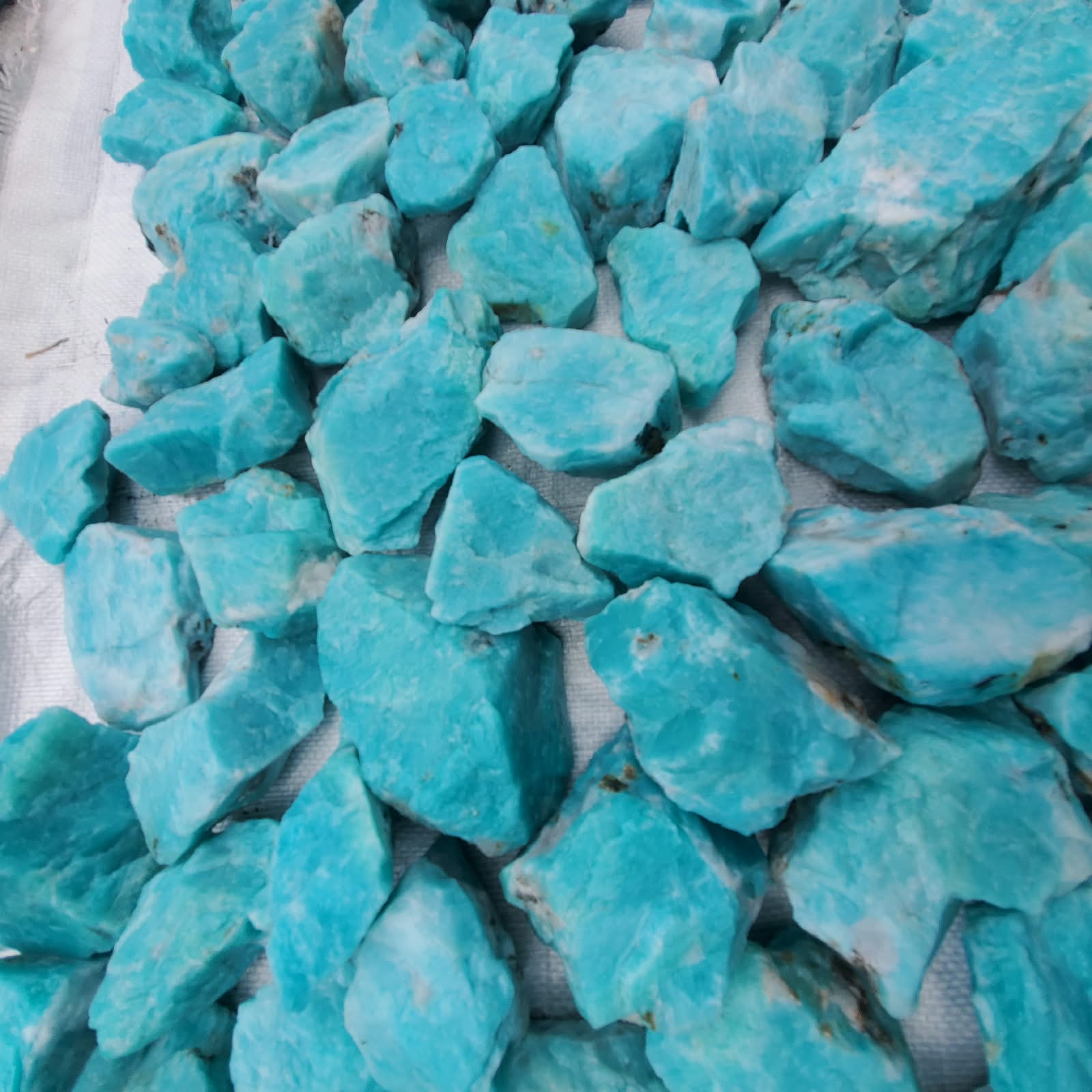 Rough blue amazonite pieces photographed in daylight